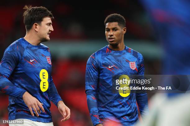 Harry Maguire and Marcus Rashford of England warm up prior to the UEFA EURO 2024 European qualifier match between England and Italy at Wembley...
