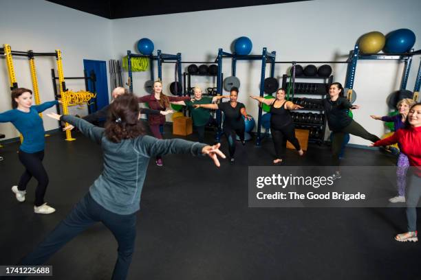 female fitness instructor teaching group of women at gym - clinic room stock pictures, royalty-free photos & images