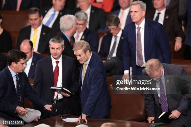 Rep. Jim Jordan talks with staff and fellow lawmakers alongside former Speaker of the House Kevin McCarthy as the House of Representatives meets to...