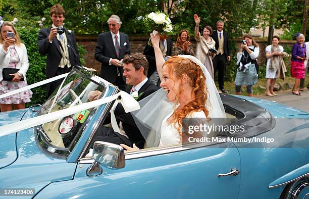 Alicia Fox-Pitt and Sebastian Stoddart leave The Church of the Holy Cross in an open-top Mercedes car after their wedding in Goodnestone on July 20,...