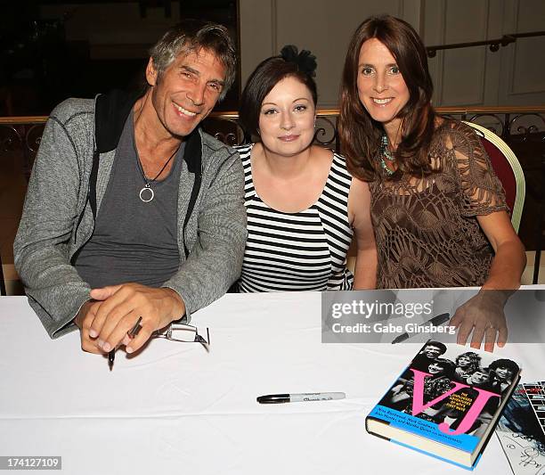 Authors and original MTV VJs Mark Goodman and Martha Quinn pose with a fan, Regina Hershberger of Ohio, at the signing of their new book "VJ: The...