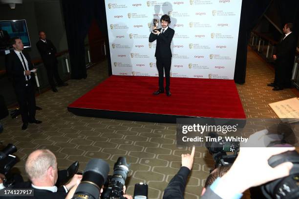 Ben Whishaw poses in the press room with his award for Best Leading Actor at the Arqiva British Academy Television Awards 2013 at the Royal Festival...