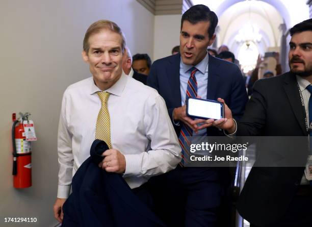 Rep. Jim Jordan walks to a meeting with House Republicans after the House of Representatives failed to elect a new Speaker of the House on the first...