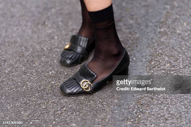 Emy Venturini wears black mesh socks from Calzedonia, black leather shoes from Gucci, during a street style fashion photo session, on October 17,...