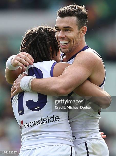 Tendai Mzungu and Ryan Crowley of the Dockers celebrate a goal during the round 17 AFL match between the Richmond Tigers and the Fremantle Dockers at...