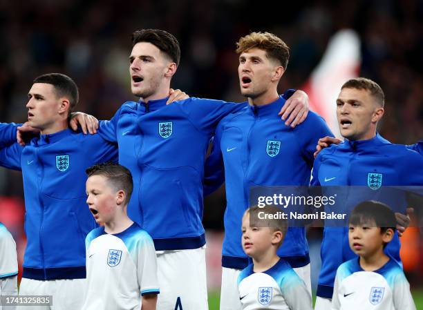 Phil Foden, Declan Rice, John Stones and Kieran Trippier of England sing the National Anthems prior to the UEFA EURO 2024 European qualifier match...