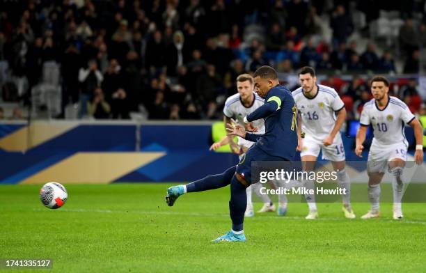 Kylian Mbappe of France scores the team's third goal from the penalty spot during the International Friendly between France and Scotland at Decathlon...