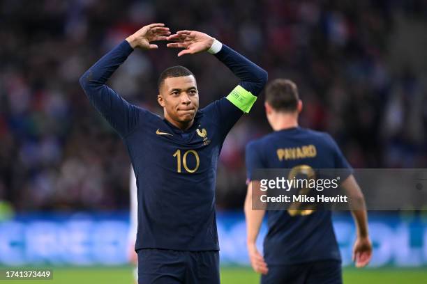 Kylian Mbappe of France celebrates towards the fans after scoring the team's third goal from the penalty spot during the International Friendly...