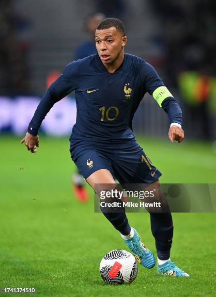Kylian Mbappe of France runs with the ball during the International Friendly between France and Scotland at Decathlon Arena on October 17, 2023 in...