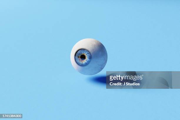 one blue eye ball levetating - eye color stock pictures, royalty-free photos & images