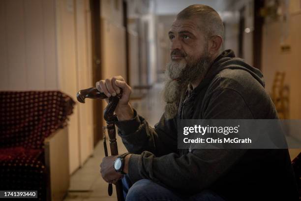 Oleksandr, call sign “Mokryi,” a 43-year-old Ukrainian soldier watches TV in a communal area at a psychiatric hospital on October 06, 2023 in Kyiv,...