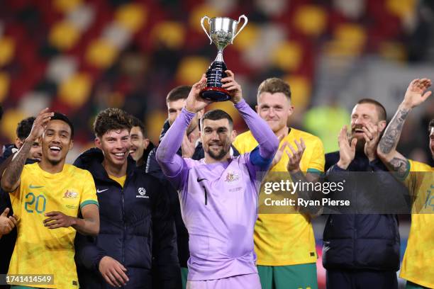 Mathew Ryan of Australia celebrates and lifts the Trans-Tasman Trophy following the Trans-Tasman Trophy international friendly match between...