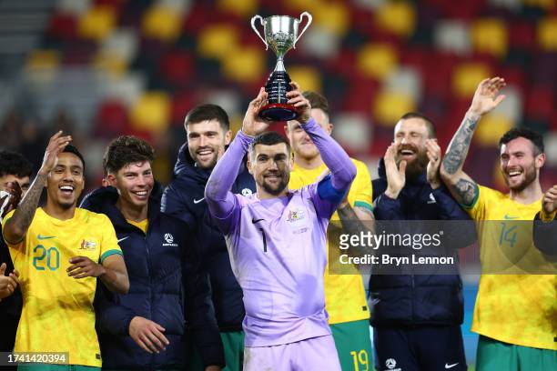 Mathew Ryan of Australia celebrates and lifts the Trans-Tasman Trophy following the Trans-Tasman Trophy international friendly match between...