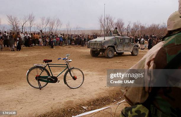 Afghani villagers from the Aroki Province travel by foot, donkey or bicycle to reach the site of the Medical Civil Action Program January 21, 2002 in...