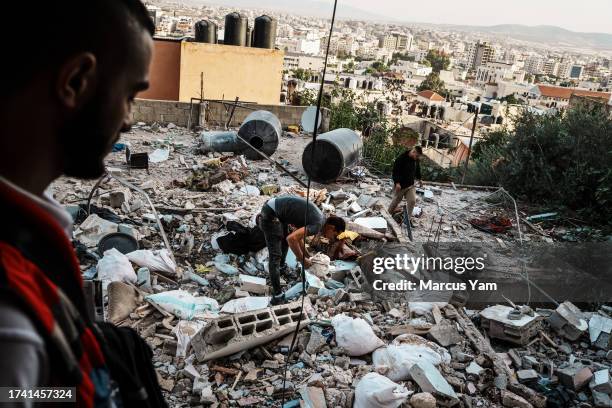 Local residents examine the aftermath of an Israeli airstrike on the Al Ansar Mosque, where two Palestinians were killed, in the refugee camp in...