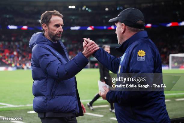 Gareth Southgate shakes hands with Steve Holland, Assistant Manager of England, after the team's victory during the UEFA EURO 2024 European qualifier...