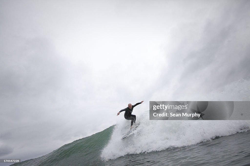 Surfer dropping in to wave
