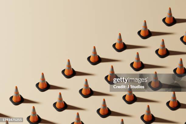grid pattern of traffic cones with copy space - cono fotografías e imágenes de stock