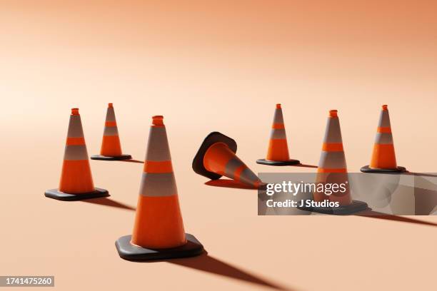 standing out from the crowd - traffic cone stock-fotos und bilder