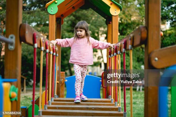 little girl playing in a park. - 3 years brunette female alone caucasian stock pictures, royalty-free photos & images