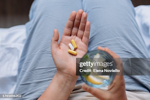 Woman taking her vitamins and supplements, Variety of pills and capsules in hands Woman taking her vitamins and supplements, Variety of pills and capsules in hands