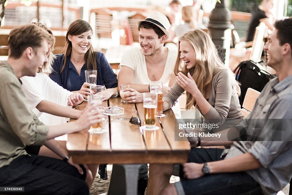 Young people drinking beer outdoors