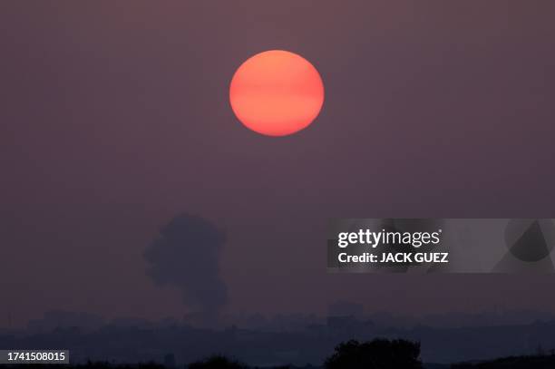 Picture taken from Israel's southern city of Sderot shows smoke billowing at sunset during a Israeli strike on Gaza on October 23 amid ongoing...