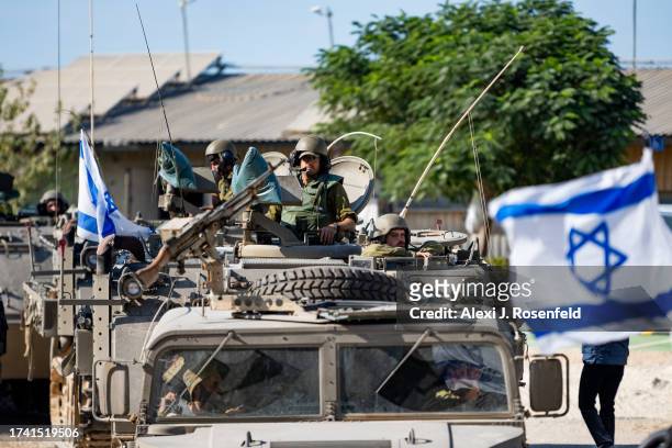 Soldiers ride in armored personnel carriers on October 17, 2023 in Be'eri, Israel. As Israel prepares to invade the Gaza Strip in its campaign to...