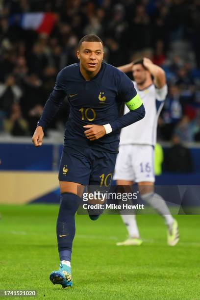 Kylian Mbappe of France celebrates after scoring the team's third goal from the penalty spot during the International Friendly between France and...