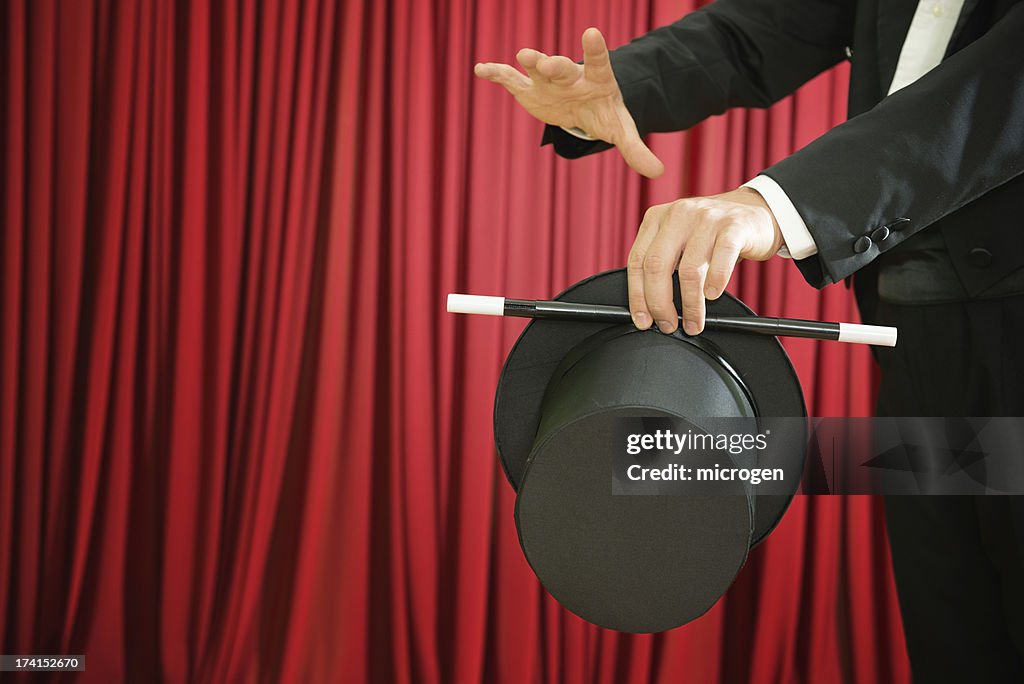 Magician performing with top hat and magic wand