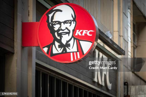 The sun shines on the logo of Colonel Sanders, founder of the Kentucky Fried Chicken fast food restaurant KFC, on October 18, 2023 in Bath, England....