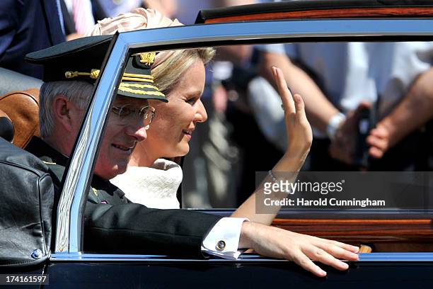 King Philippe of Belgium and Queen Mathilde of Belgium are seen being driven to the Royal Palace during the abdication of King Albert II of Belgium,...