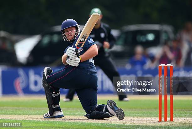 Richard Levi of Northants hits out on his way to a half century as Ben Cox of Worcestershire looks on during the Friends Life T20 match between...