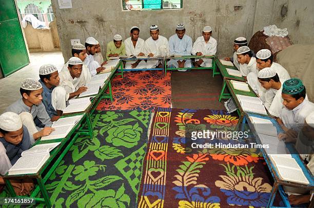 Muslim children reciting verses from Islam's holy book Quran on the 13th day of Ramadan at a Madrasa on July 21, 2013 in Noida, India. Islam's holy...