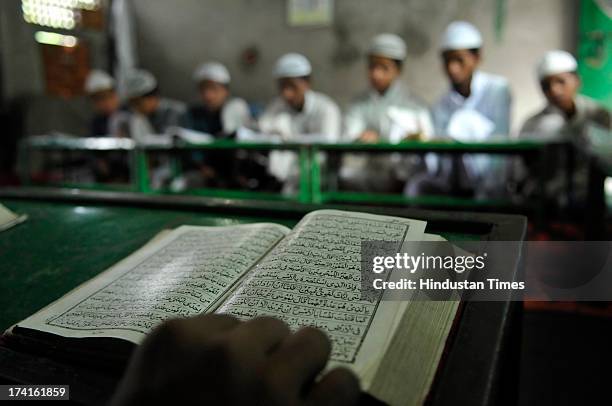 Muslim children reciting verses from Islam's holy book Quran on the 13th day of Ramadan at a Madrasa on July 21, 2013 in Noida, India. Islam's holy...