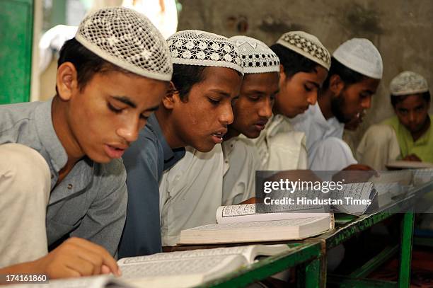 Muslim children reciting verses from Islam's holy book Quran on the 13th day of Ramadan at a Madrasa on July 21, 2013 in Noida, India. Islam's holy...