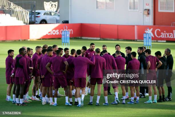 Sevilla players gather on the pitch during a training session at the Jose Ramon Cisneros Palacios sports city in Seville on October 23 on the eve of...