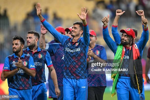 Afghanistan's players greet their fans at the end of the 2023 ICC Men's Cricket World Cup one-day international match between Pakistan and...