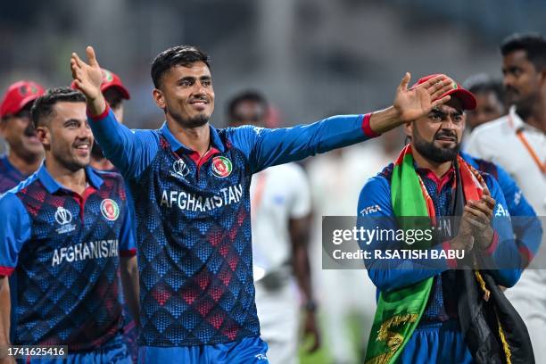 Afghanistan's players greet their fans at the end of the 2023 ICC Men's Cricket World Cup one-day international match between Pakistan and...
