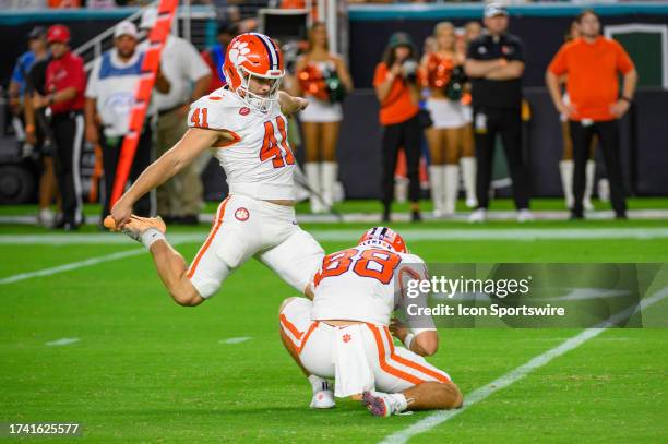 Clemson wide receiver Clay Swinney holds the ball as Clemson kicker Jonathan Weitz kicks for an extra point during the college football game between...