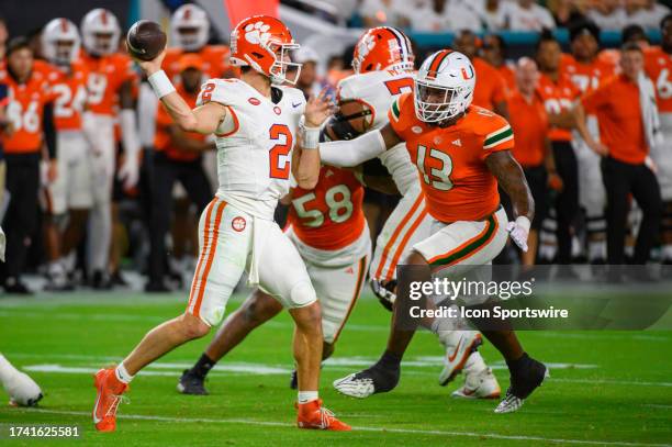 Clemson quarterback Cade Klubnik throws the ball under pressure from Miami defensive lineman Chantz Williams during the college football game between...