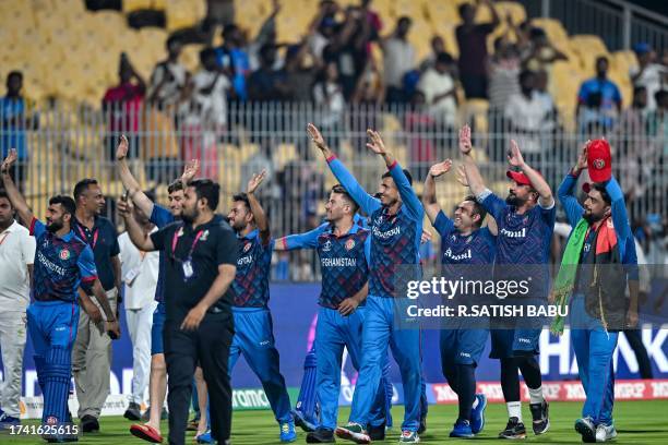 Afghanistan's players greet their fans at the end of the 2023 ICC Men's Cricket World Cup one-day international match between Pakistan and...