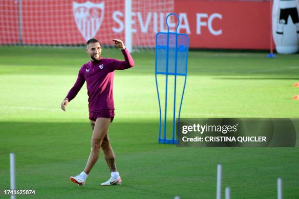 Sevilla's Serbian midfielder Nemanja Gudelj waves during a training session at the Jose Ramon Cisneros Palacios sports city in Seville on October 23...