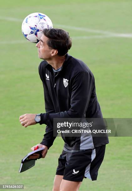 Sevilla's Uruguayan coach Diego Alonso plays with a ball as he heads a training session at the Jose Ramon Cisneros Palacios sports city in Seville on...