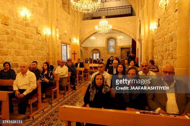 Palestinian christians attend mass on October 23 for those killed during a strike on the Greek Orthdox church of Saint Porphyrius in Gaza City on...