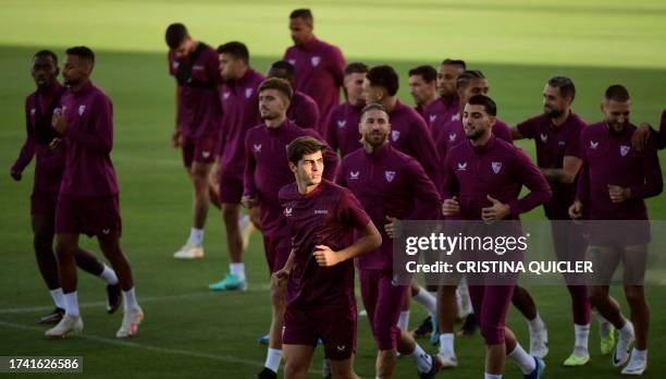 Sevilla's Spanish midfielder Juanlu Sanchez jogs with teammates during a training session at the Jose Ramon Cisneros Palacios sports city in Seville...