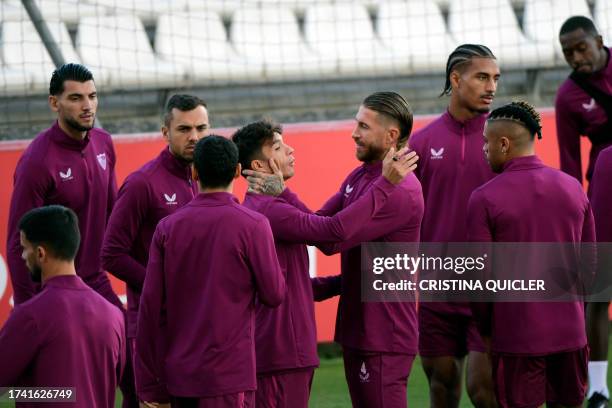 Sevilla's Spanish defender Sergio Ramos talks with Sevilla's Spanish midfielder Oliver Torres during a training session at the Jose Ramon Cisneros...