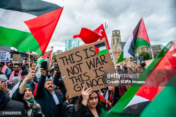 Protester holds a placard saying "This is not war, This is Genocide" during the demonstration. Palestinians and their supporters keep protesting to...