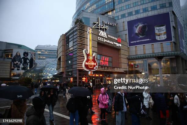 View of the Golden Terraces shopping mall and people on a sidewalk in Warsaw, Poland on October 20, 2023.