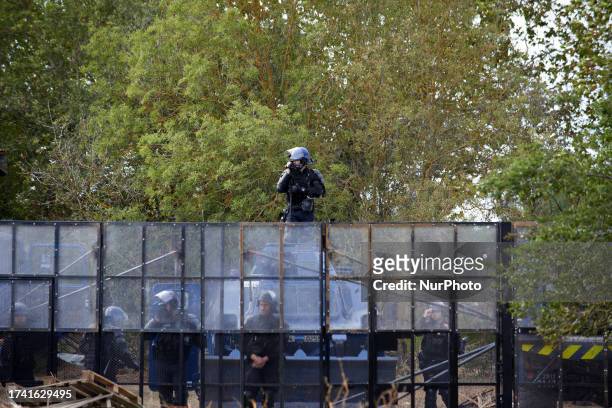Gendarme mobile films protesters behind an anti riot wall.Protesters decided to create a ZAD in a farm 'La Cremade' nearby before being violently...